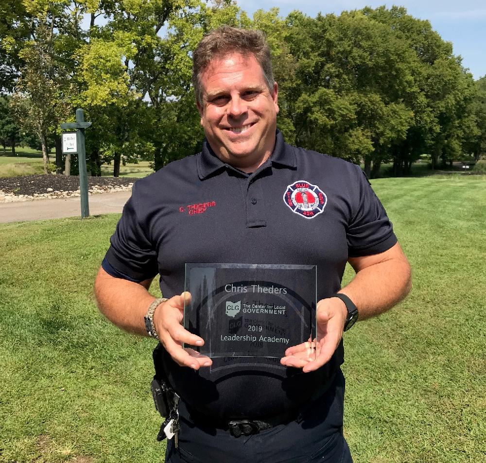 Fire Chief Chris Theders with graduation award 
